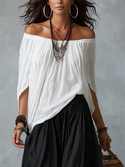 Conjunto de top blanco con hombros descubiertos y pantalón de pierna ancha.